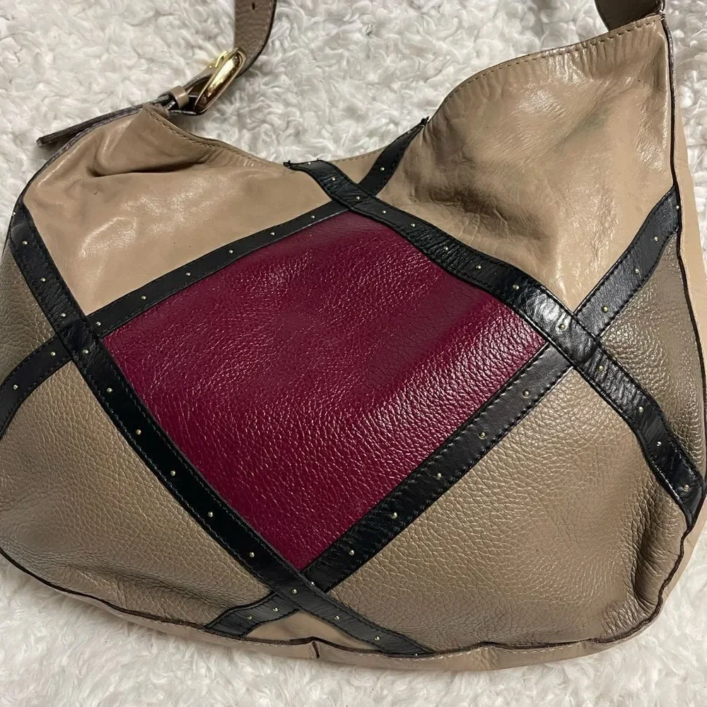 A. Bellucci leather Khaki Satchel with patch work accents, gay, burgundy &black.